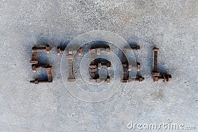 Letter word is steel by old and rusty nut on dirty ground Stock Photo